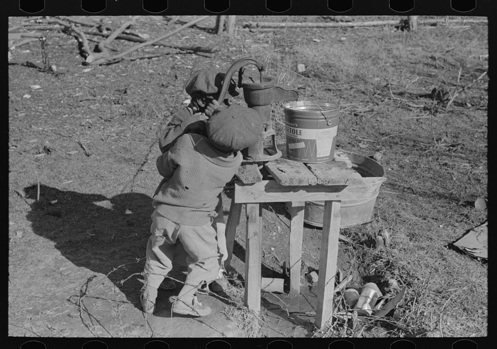 Library of Congress Photo: "Children of Negro sharecropper pumping water. Family will be resettled at Transylvania Project, Louisiana"